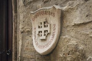 Ordo Equestris Sancti Sepulcri Hierosolymitani - coat of arms of Order of the Holy Sepulchre on the wall of Ruprechtskirche - the oldest church in Vienna. Vienna, Austria - December 17 2014.